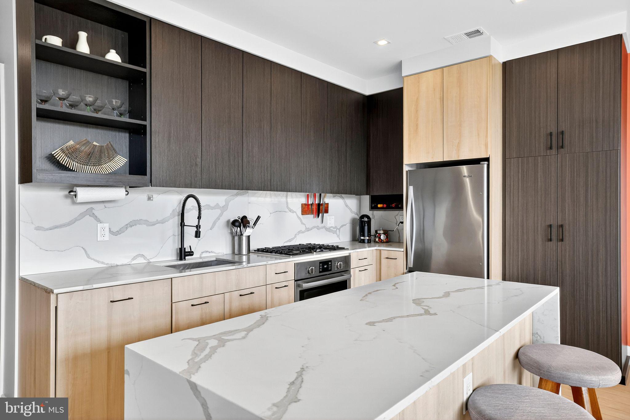 900 11th Street Southeast, Unit 308 Washington, DC 20003 - Photo 7 of 36 a kitchen with a sink a refrigerator and cabinets
