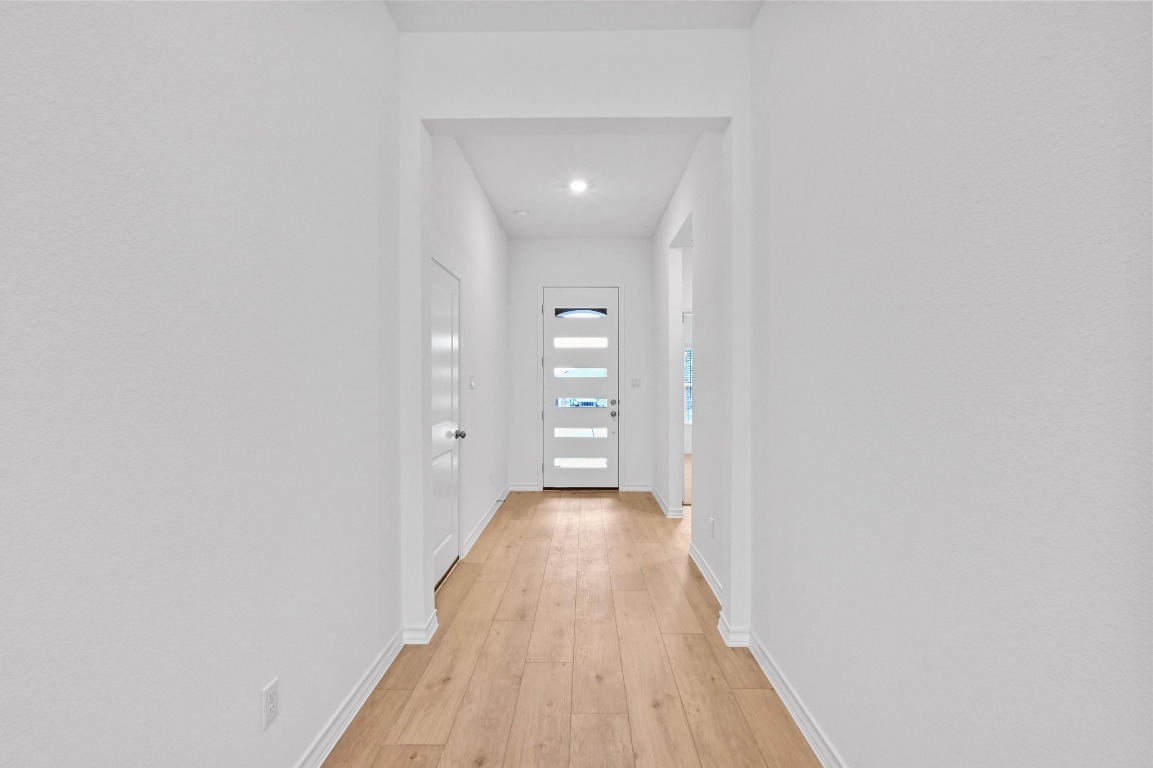 1617 Dove Rnch Road Georgetown, TX 78628 - Photo 5 of 25 a view of a hallway with wooden floor and closet