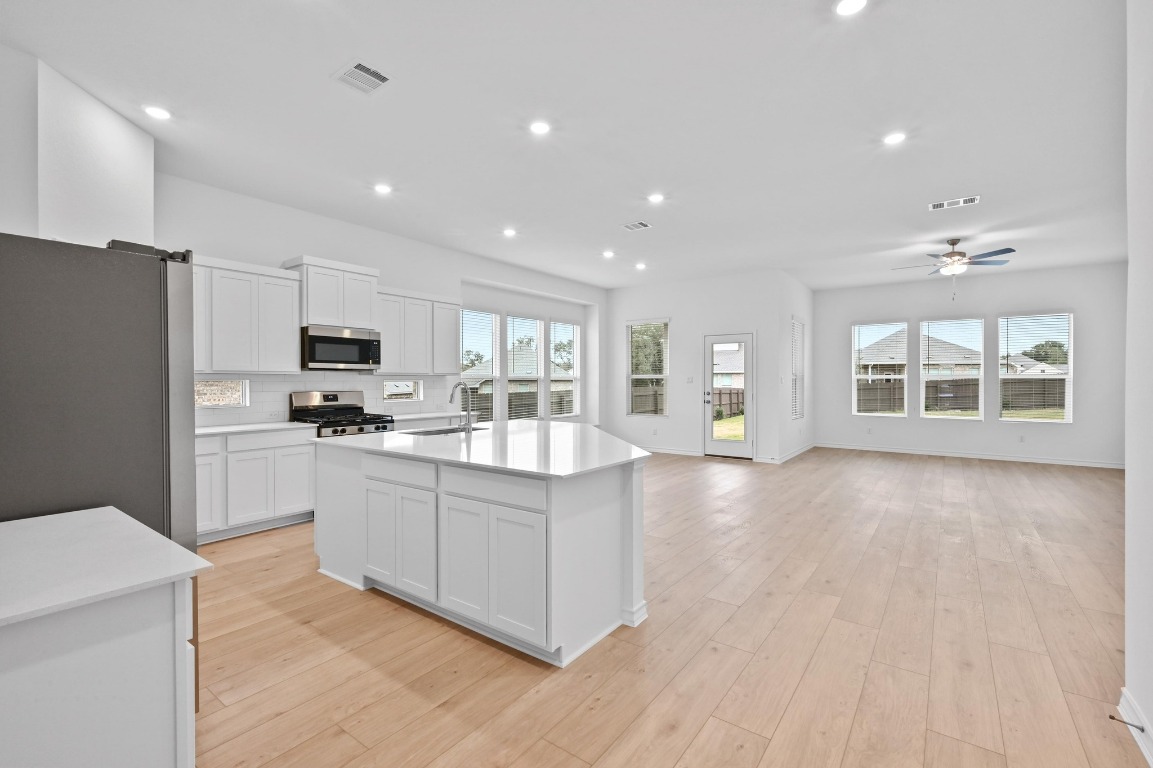 1617 Dove Rnch Road Georgetown, TX 78628 - Photo 24 of 25 a large kitchen with stainless steel appliances granite countertop a stove a sink dishwasher and a refrigerator