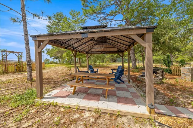 a view of a patio with chairs and a yard
