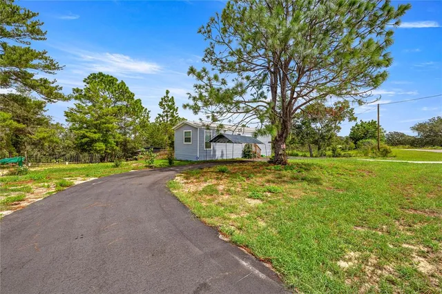 a view of a house with a yard and a garage