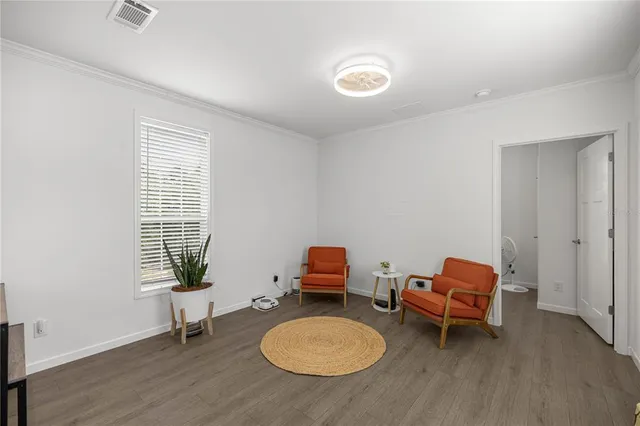 a kitchen with furniture and a wooden floor