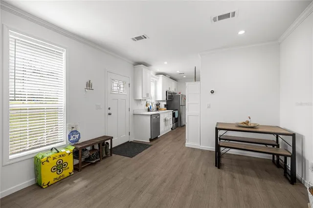 a kitchen with a sink a refrigerator and cabinets