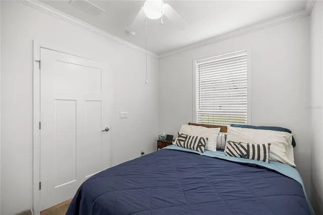 a bedroom with a bed and a window