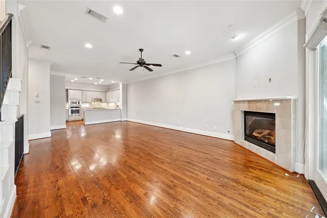 a view of an empty room with a fireplace and a window