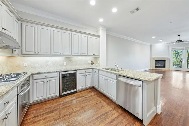 a kitchen with granite countertop a sink stove and cabinets