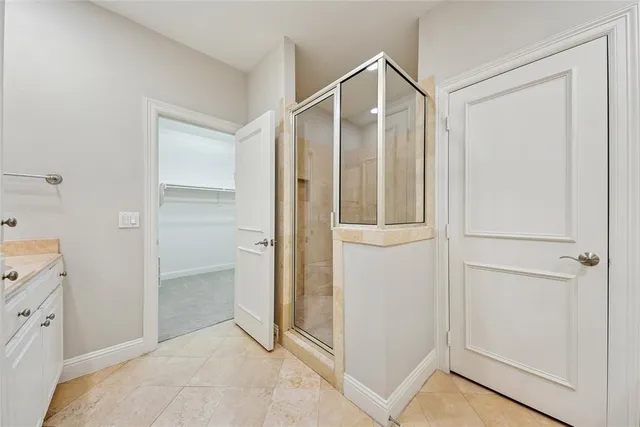 a bathroom with a shower and a sink