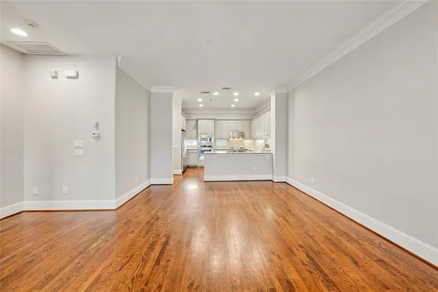 a view of a kitchen with wooden floor and a kitchen