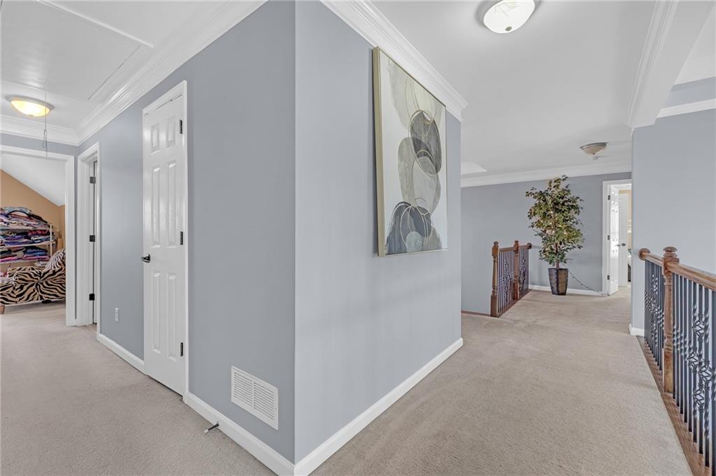 604 Arbor Ridge Loganville, GA 30052 - Photo 18 of 39 a view of a hallway with paintings on the wall