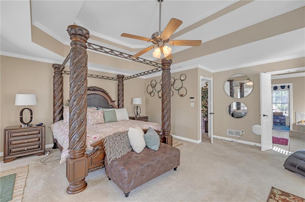 604 Arbor Ridge Loganville, GA 30052 - Photo 20 of 39 a bedroom with furniture and a chandelier
