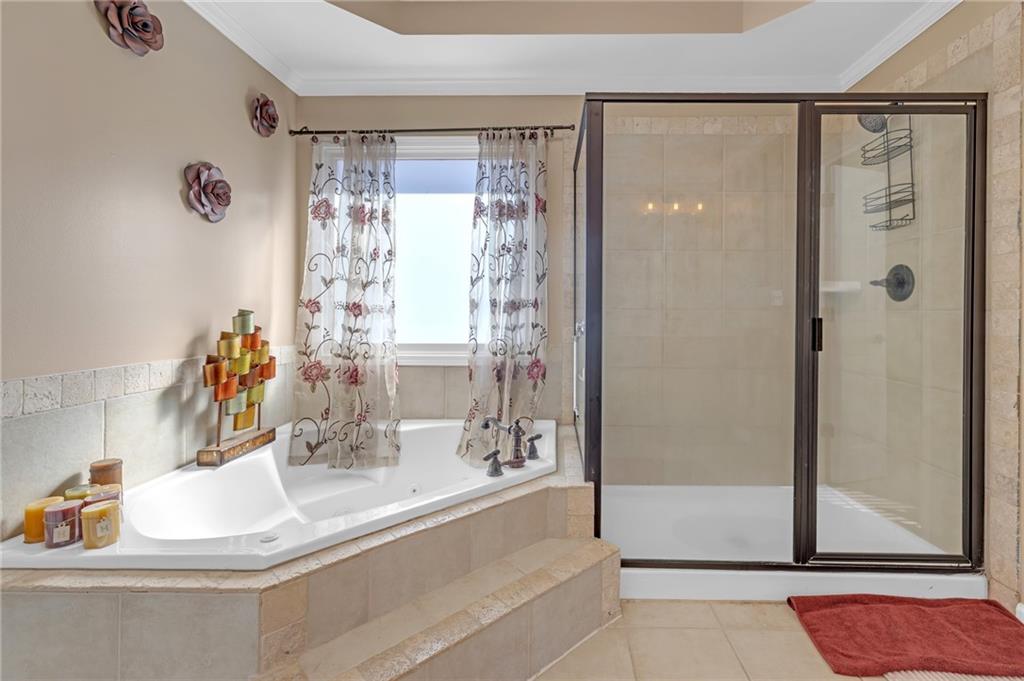 604 Arbor Ridge Loganville, GA 30052 - Photo 24 of 39 a bathroom with a granite countertop sink a mirror and shower