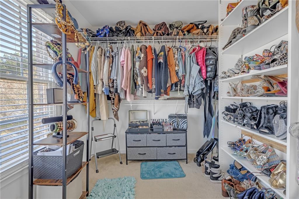 604 Arbor Ridge Loganville, GA 30052 - Photo 26 of 39 a view of walk in closet with clothes and shoes