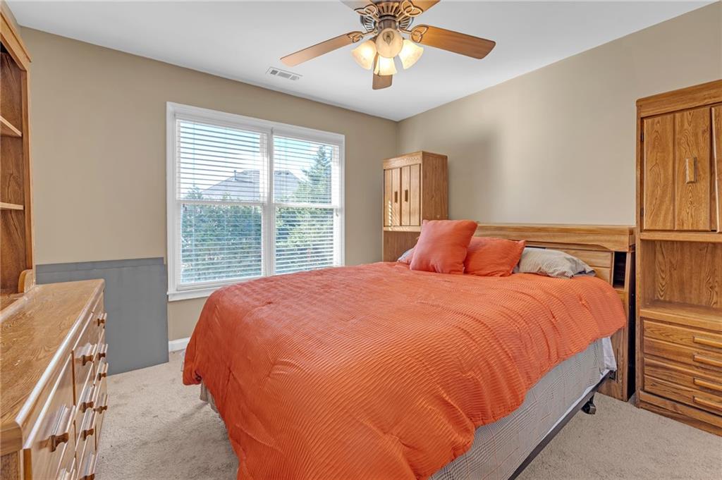 604 Arbor Ridge Loganville, GA 30052 - Photo 29 of 39 a large bed sitting in a bedroom next to a window