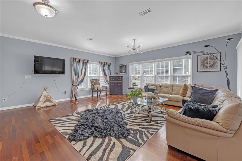 604 Arbor Ridge Loganville, GA 30052 - Photo 7 of 39 a living room with furniture and a flat screen tv