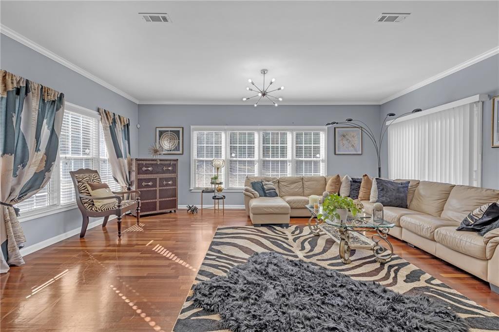 604 Arbor Ridge Loganville, GA 30052 - Photo 8 of 39 a living room with furniture potted plant and a window