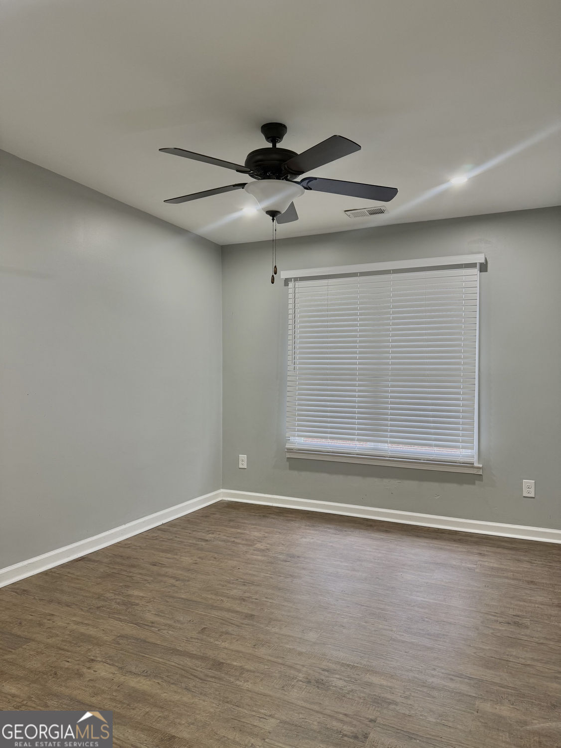 3406 Uncle Genes Way Southeast Conyers, GA 30013 - Photo 11 of 17 a view of an empty room with wooden floor and a window