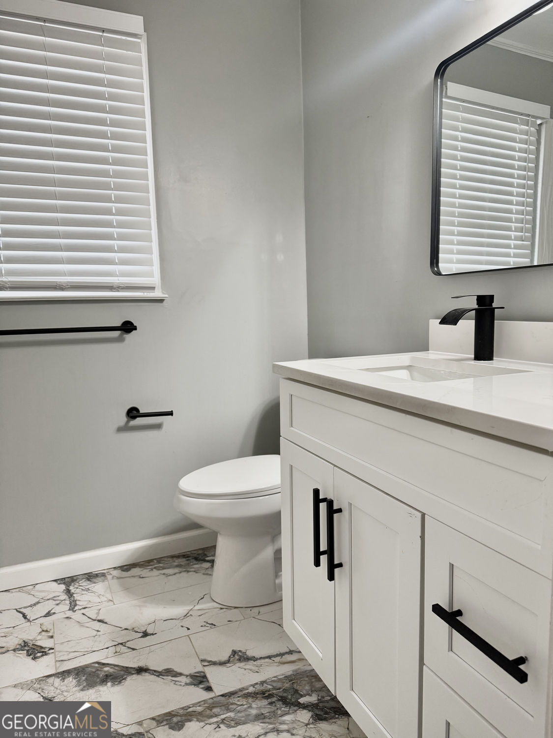 3406 Uncle Genes Way Southeast Conyers, GA 30013 - Photo 12 of 17 a bathroom with a sink a toilet and a window
