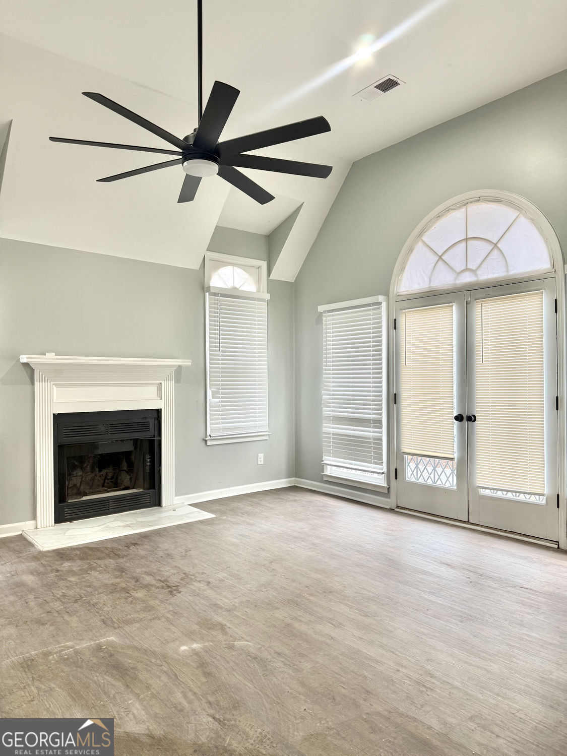 3406 Uncle Genes Way Southeast Conyers, GA 30013 - Photo 13 of 17 a view of an empty room with a fireplace and a window