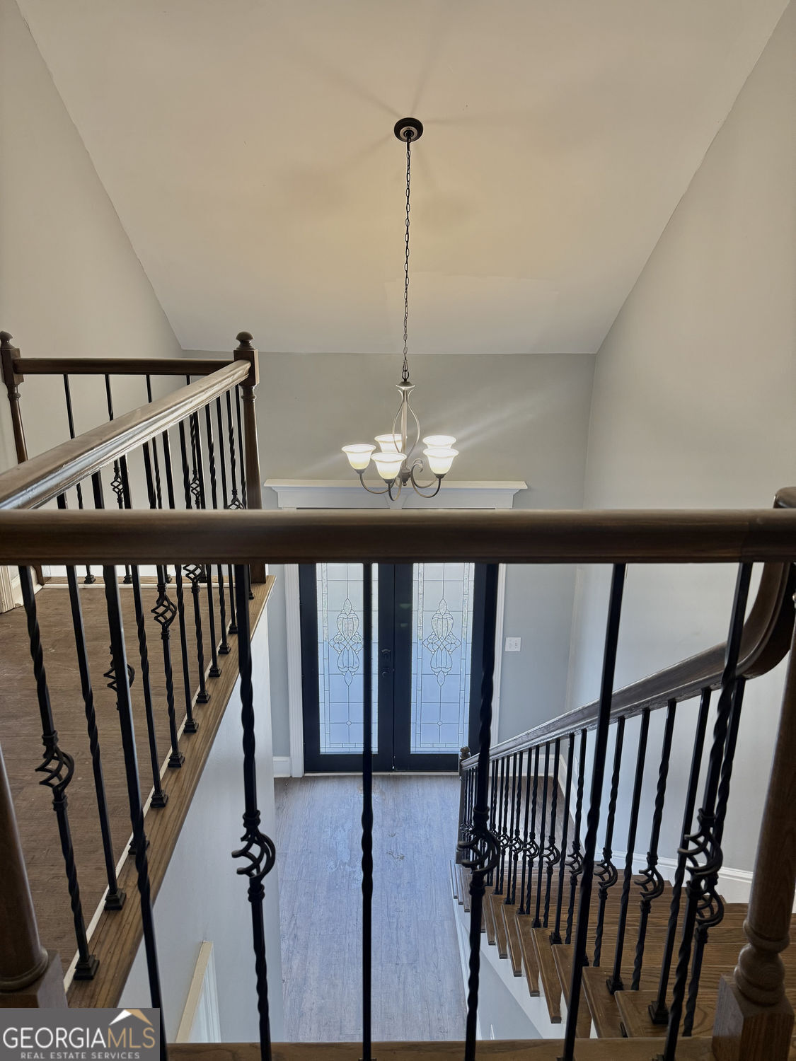 3406 Uncle Genes Way Southeast Conyers, GA 30013 - Photo 15 of 17 a view of staircase with railing fan and wooden floor