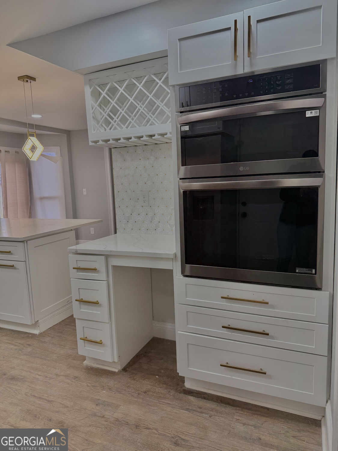 3406 Uncle Genes Way Southeast Conyers, GA 30013 - Photo 5 of 17 a kitchen with white cabinets and stainless steel appliances