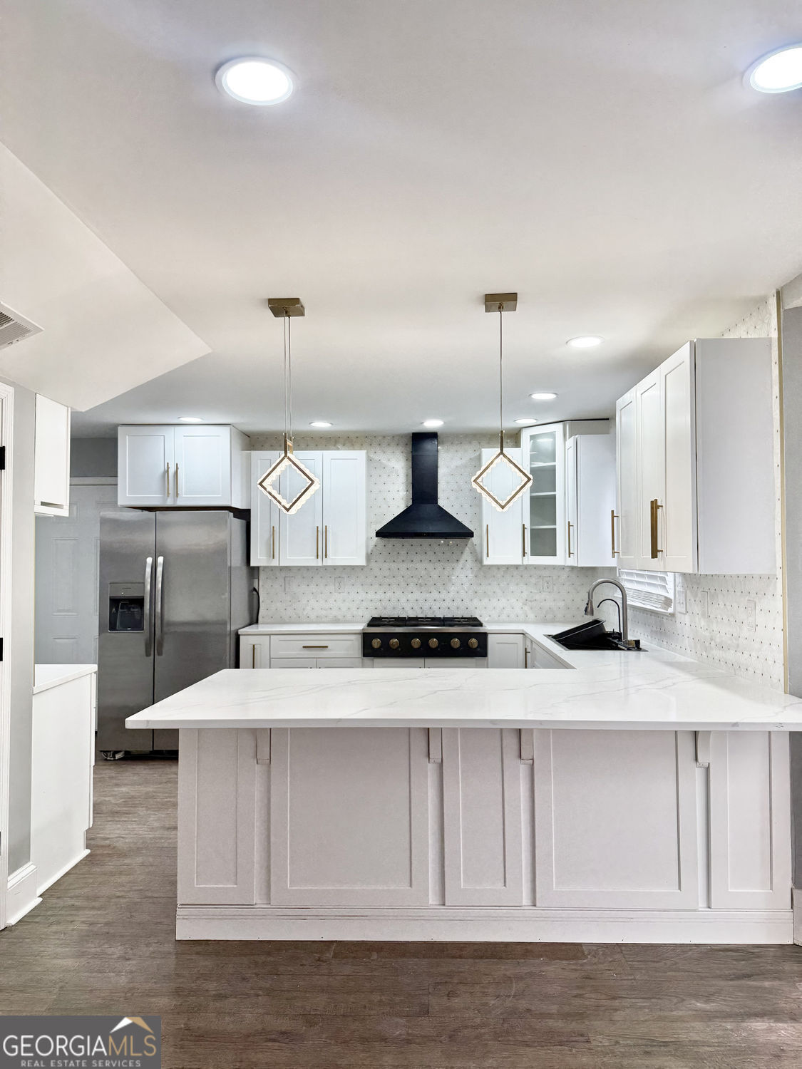3406 Uncle Genes Way Southeast Conyers, GA 30013 - Photo 6 of 17 a kitchen with kitchen island granite countertop a sink cabinets and stainless steel appliances