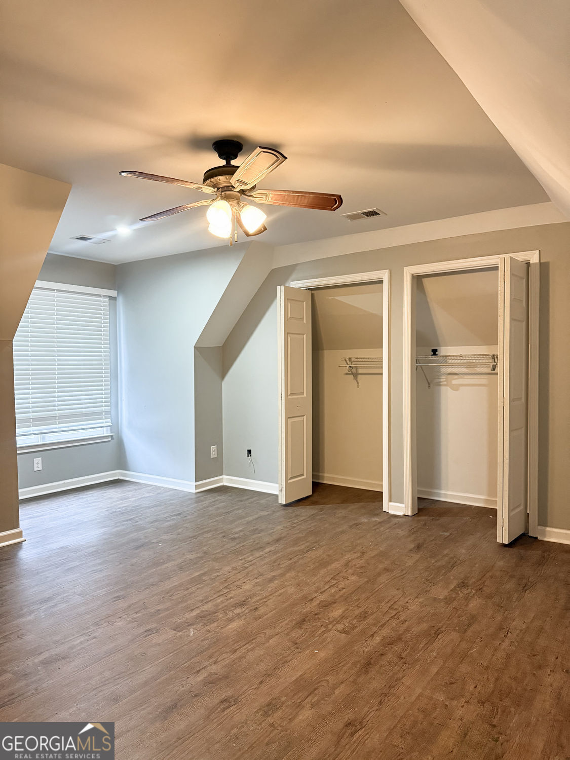 3406 Uncle Genes Way Southeast Conyers, GA 30013 - Photo 10 of 17 a view of a big room with closet and a chandelier fan