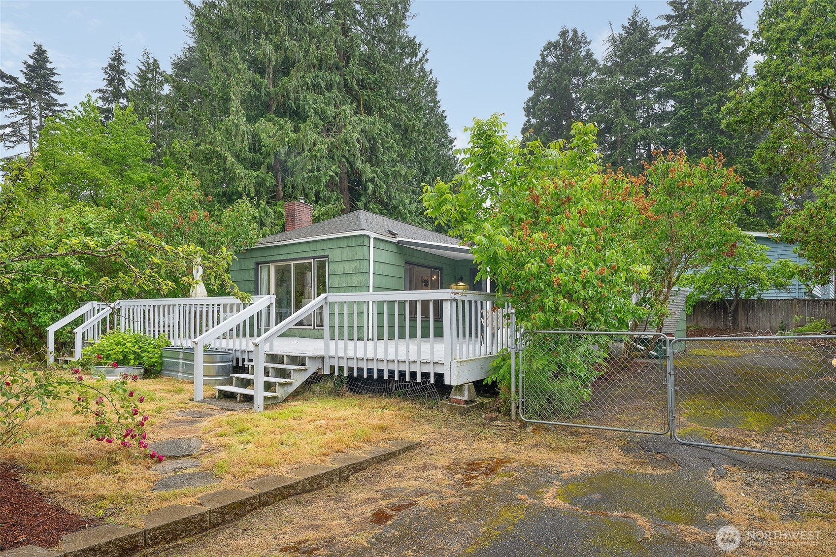 17633 10th Avenue Northeast Shoreline, WA 98155 - Photo 29 of 33 an outdoor view of house with swimming pool and trees in the background