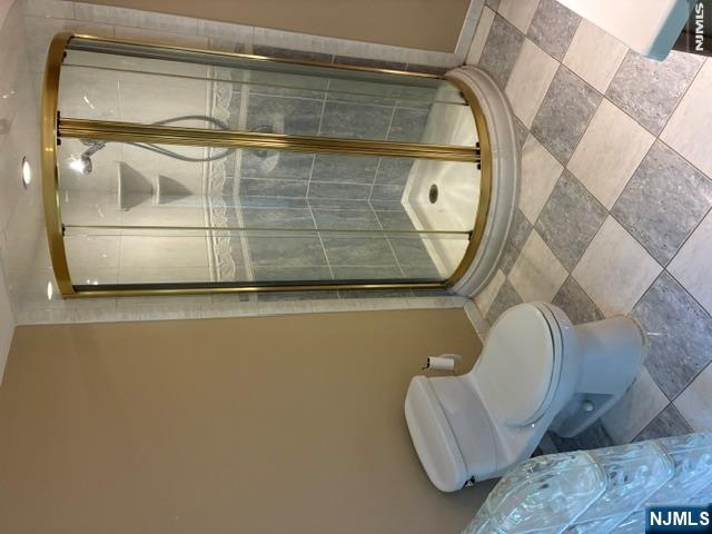 19 Crescent Road Wayne, NJ 07470 - Photo 11 of 26 a white toilet sitting next to a shower