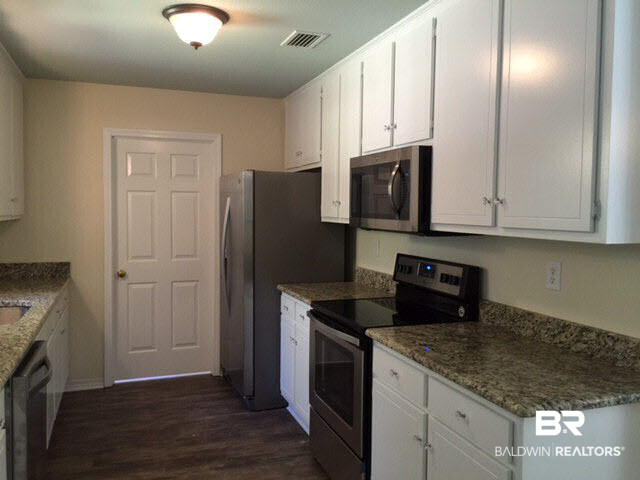 5249 Pine Road Orange Beach, AL 36561 - Photo 10 of 24 Floor to ceiling white cabinets, new Whirlpool appliances and new granite.
