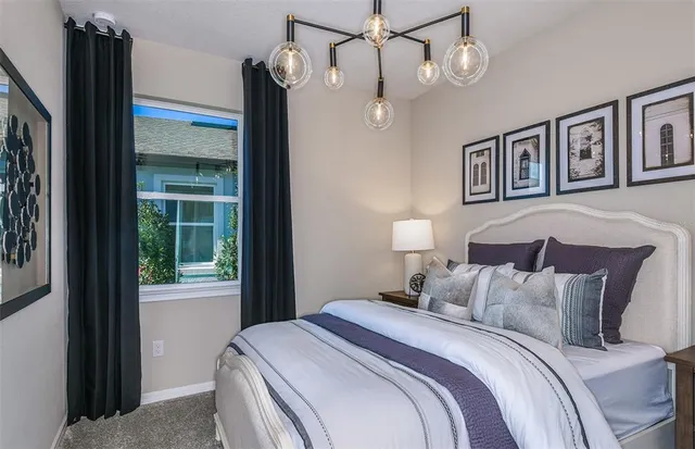 a bedroom with a large bed and a large window