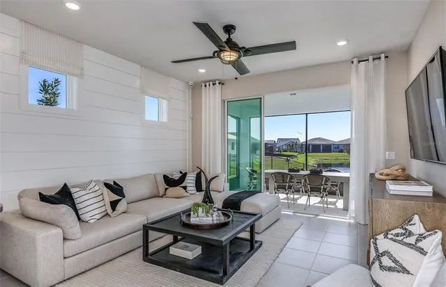 a living room with furniture and a large window