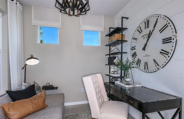 a living room with furniture a rug and a mirror