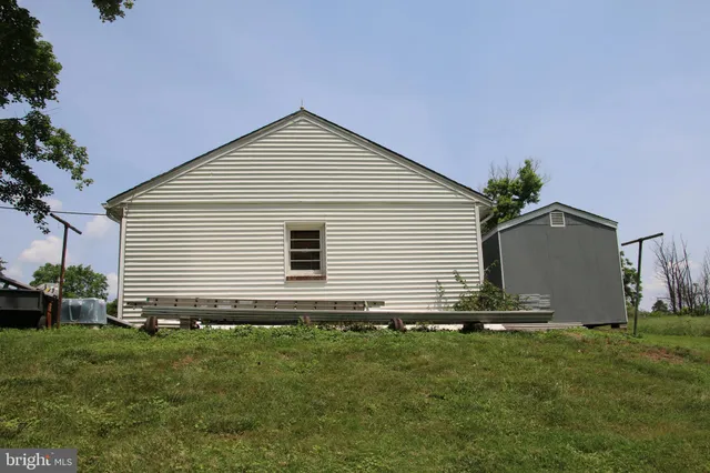 a view of a house with a yard and tree