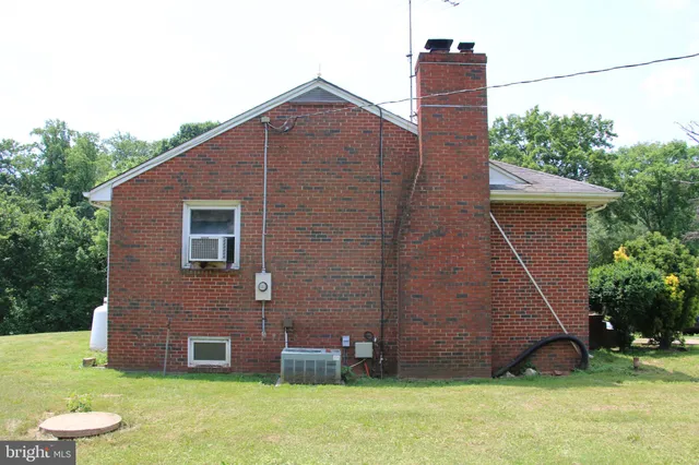 a view of a house with a bed and furniture