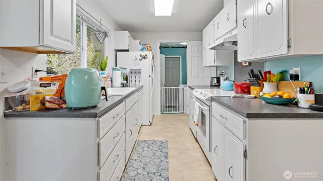 a kitchen with stainless steel appliances granite countertop lots of counter top space and cabinets