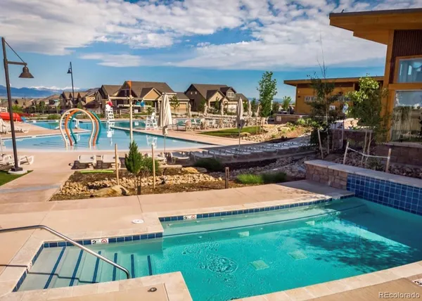 a view of a swimming pool with furniture
