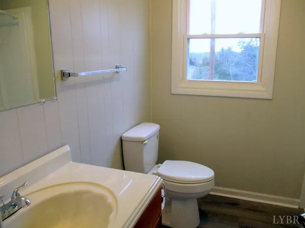 a white toilet sitting next to a bathroom sink and tub