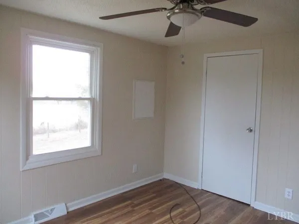 a view of room with a window and ceiling fan