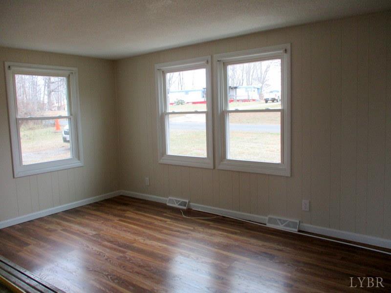 3009 Pocket Road Hurt, VA 24563 - Photo 3 of 25 an empty room with wooden floor and windows