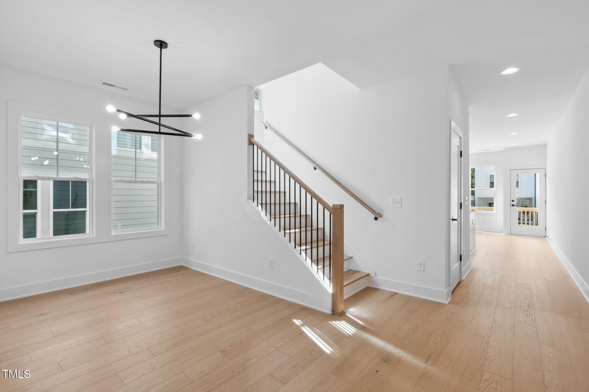 5049 Lundy Drive, Unit 102 Raleigh, NC 27606 - Photo 13 of 48 a view of a room with stairs and windows