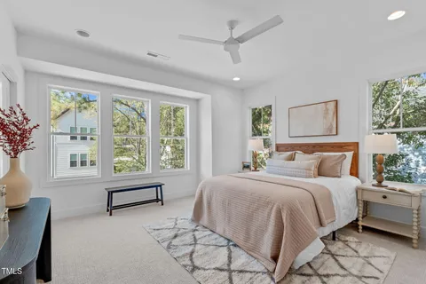 a bedroom with a large bed and a large window