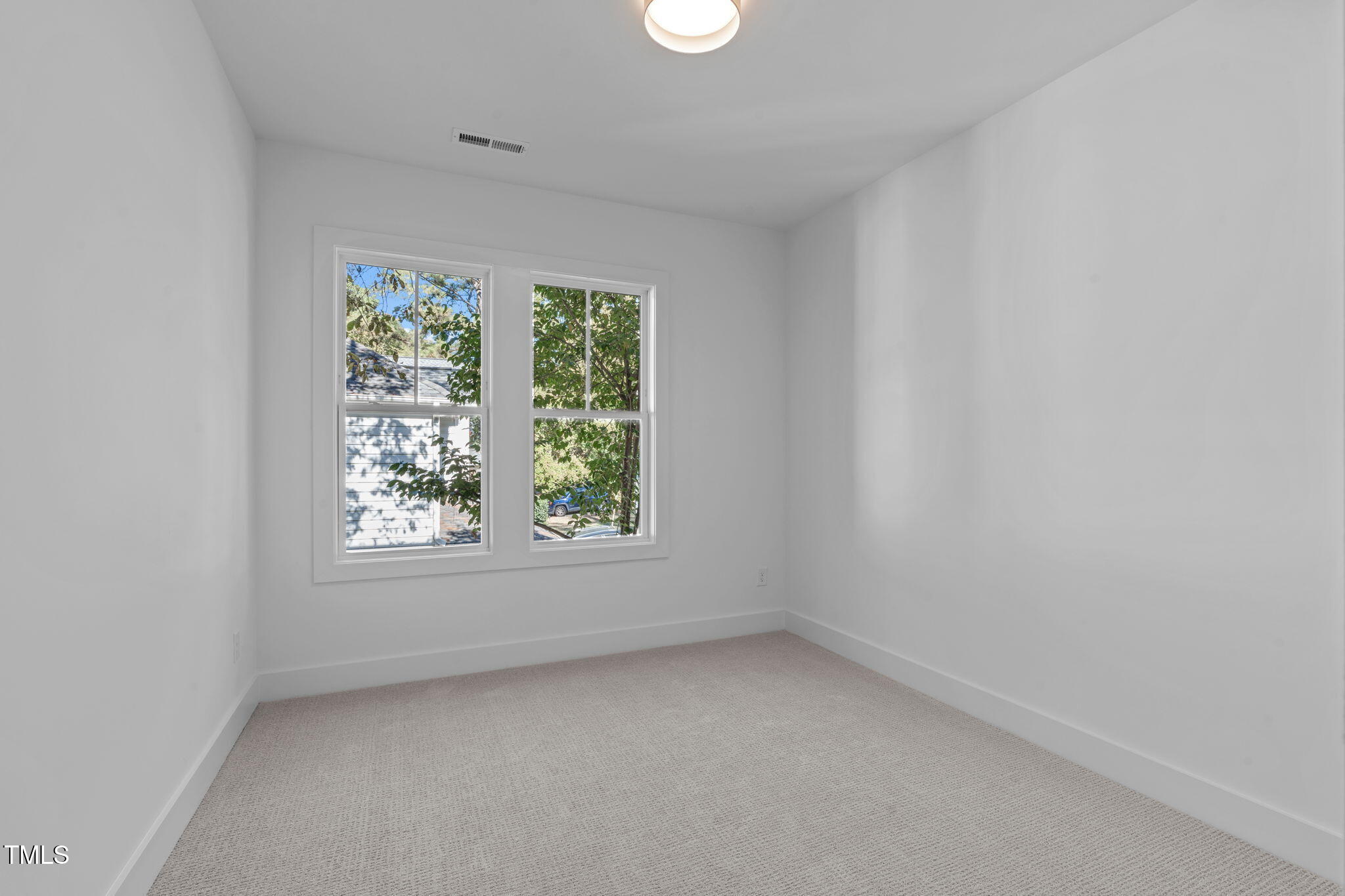 5049 Lundy Drive, Unit 102 Raleigh, NC 27606 - Photo 19 of 48 an empty room with a window