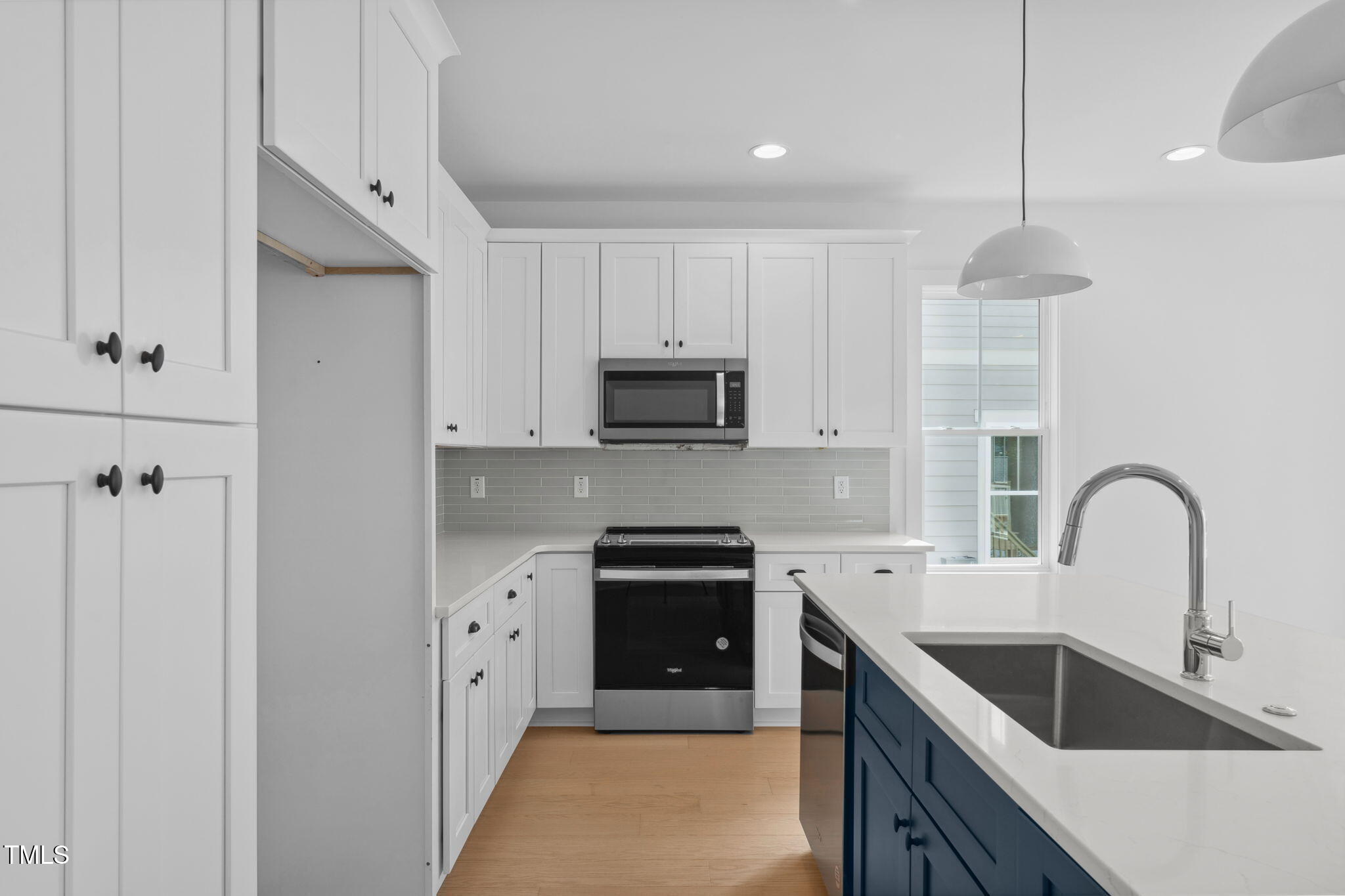 5049 Lundy Drive, Unit 102 Raleigh, NC 27606 - Photo 2 of 48 a kitchen with a sink and a stove top oven