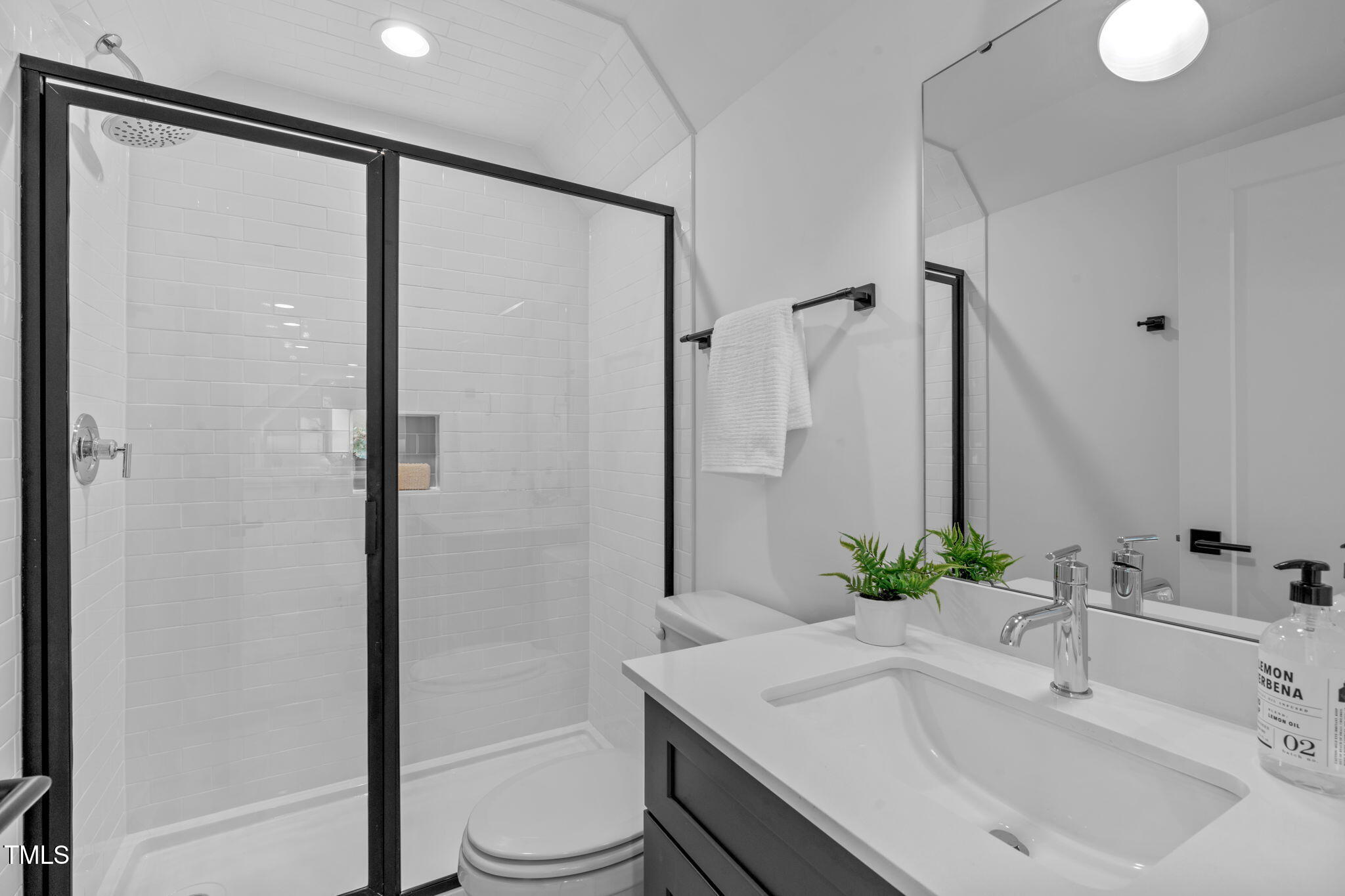 5049 Lundy Drive, Unit 102 Raleigh, NC 27606 - Photo 30 of 48 a bathroom with a sink toilet and shower