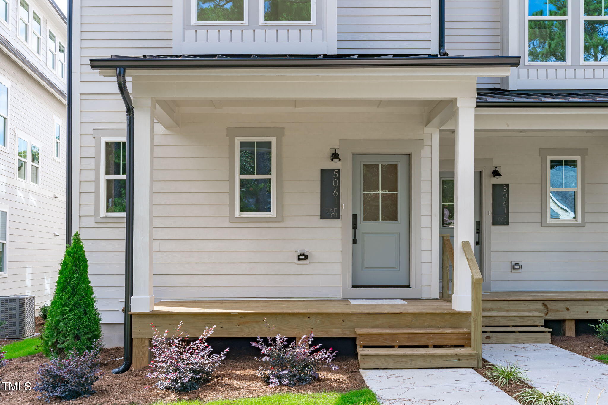 5049 Lundy Drive, Unit 102 Raleigh, NC 27606 - Photo 31 of 48 a front view of a house with a garden