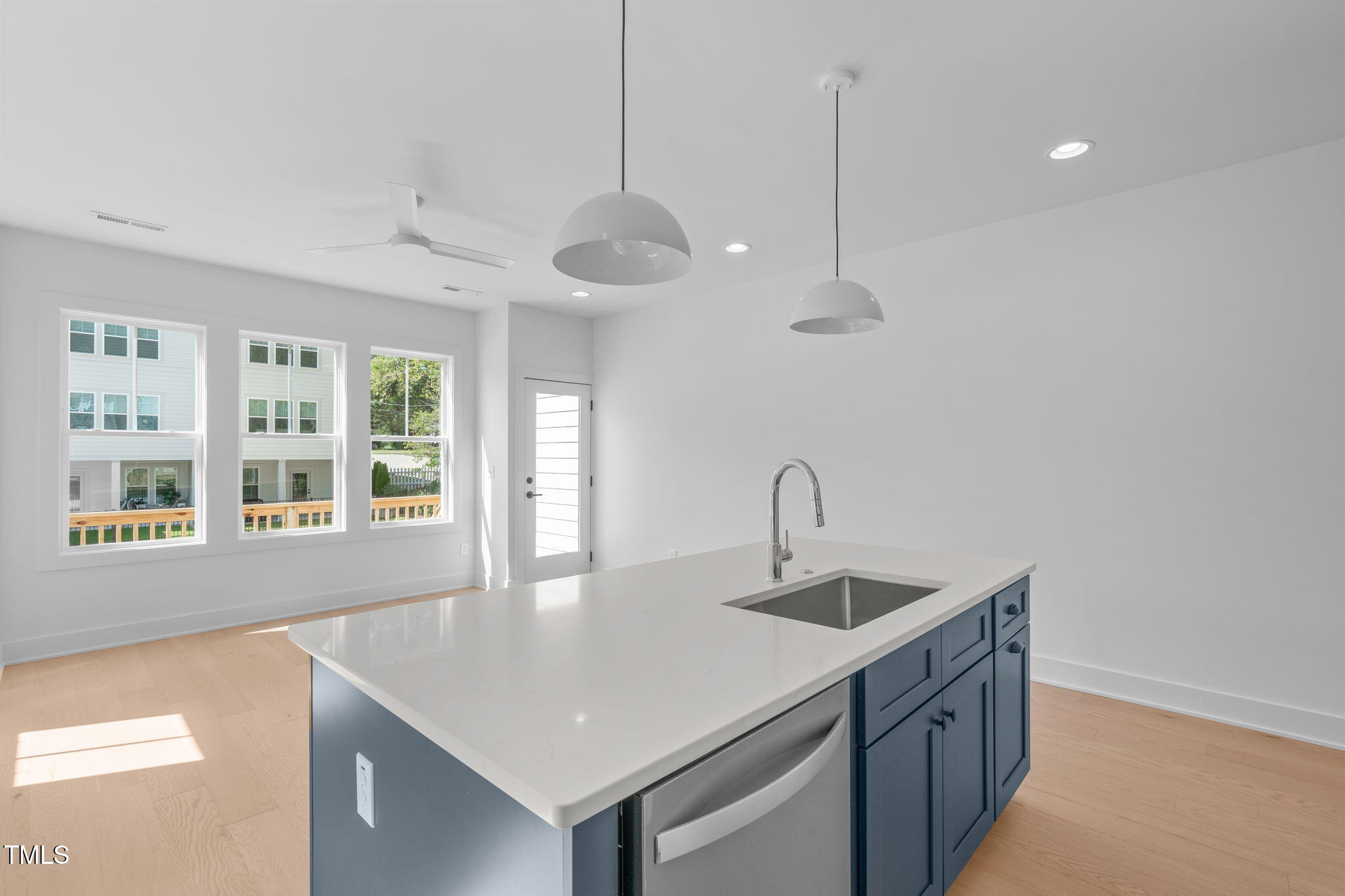 5049 Lundy Drive, Unit 102 Raleigh, NC 27606 - Photo 4 of 48 a kitchen with stainless steel appliances granite countertop a sink a window and wooden floor