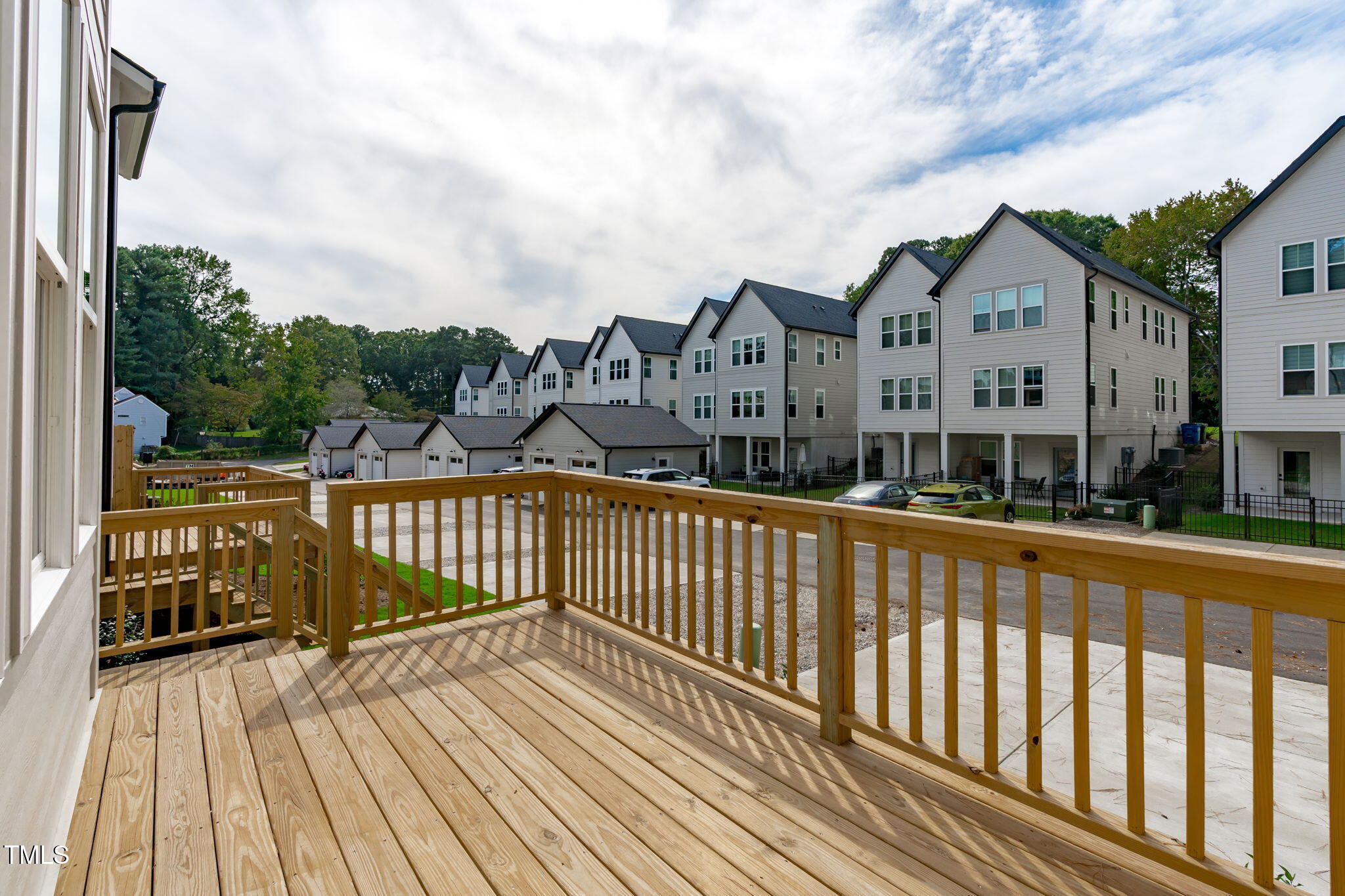5049 Lundy Drive, Unit 102 Raleigh, NC 27606 - Photo 9 of 48 a view of a wooden deck with a yard