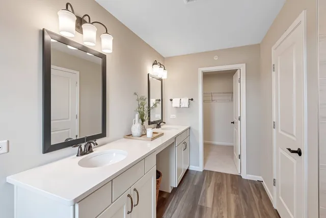 a bathroom with 2 sink and a mirror