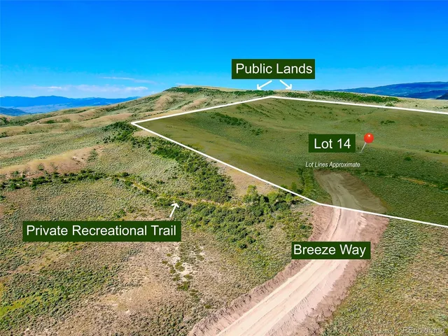 a view of a field with an ocean view