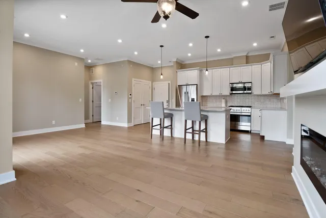 a view of kitchen with kitchen island and stainless steel appliances